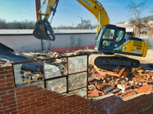 Backhoe taking down a building.